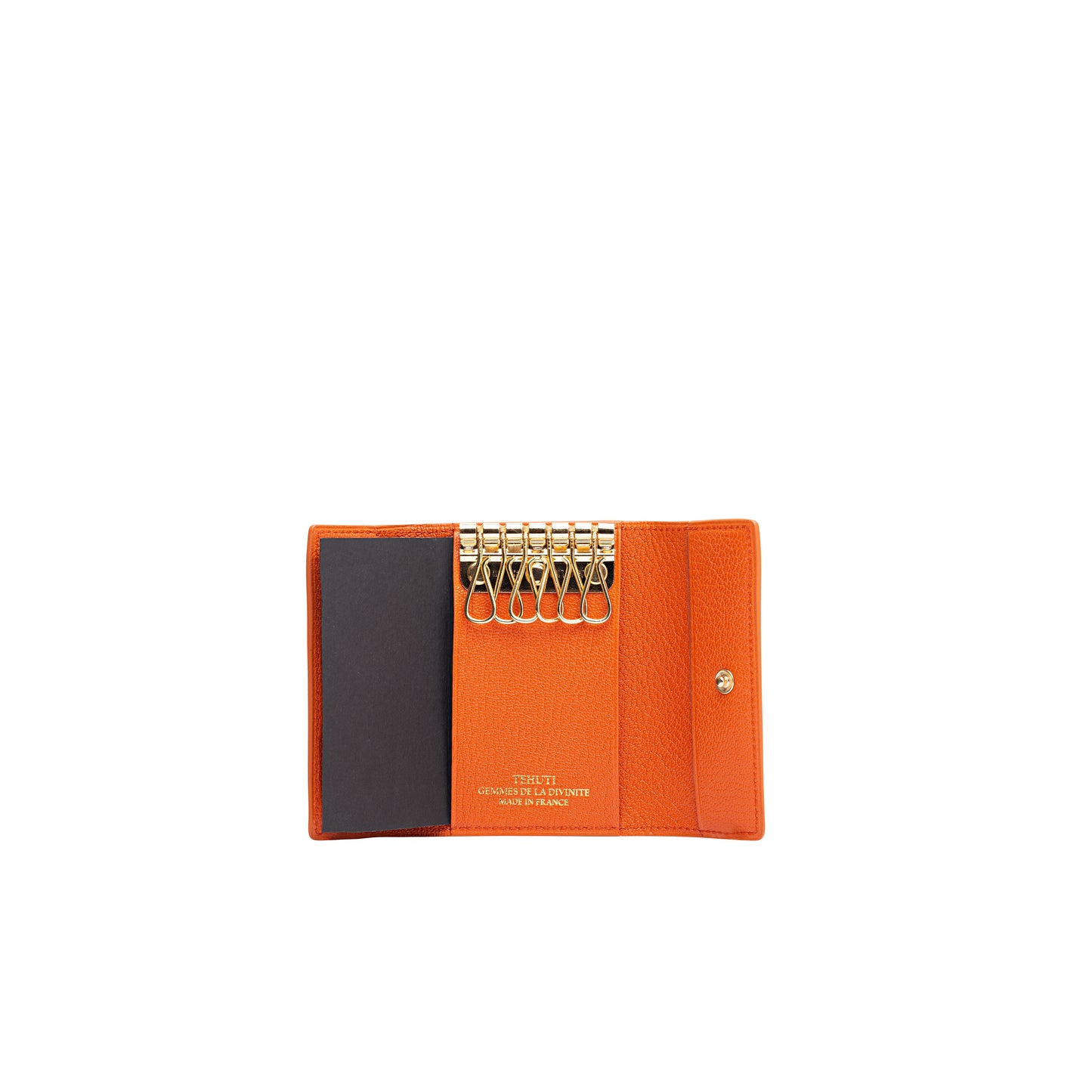 Small keyholder in orange shiny lizard leather. Six internal key holders and one open compartment inside. Flap closure with clip.